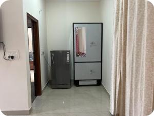 a room with a refrigerator and a mirror at Himshikha Colony 2bhk in Surajpur