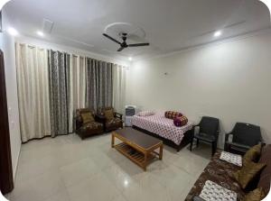 a living room with a couch and a table and chairs at Himshikha Colony 2bhk in Surajpur