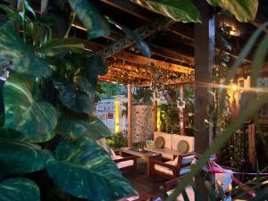 a patio with wooden tables and a plant at Angel Hotels in Lagos