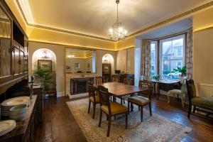 a kitchen and dining room with a table and chairs at Trinity Boutique B&B in Peterhead