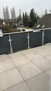 a fence on the side of a patio at Quiet 2-Bedroom Apartment - Ideal for Families & Work Stays in Munich