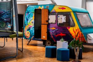 a brightly painted van parked in a room at WOT Peniche Social in Peniche