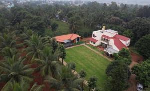 an aerial view of a house in the forest at Eeshaavasya Homestay in Bangalore