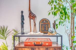 a table with figurines of a giraffe and a plate at Bright house ideal for exploring Bordeaux in Bordeaux