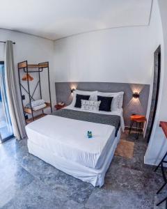 a bedroom with a large white bed in a room at Pousada Mon Gâté in Japaratinga +70 photos