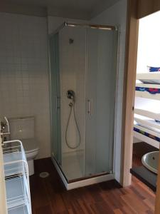 baño con ducha y puerta de cristal en Apartamento Alvaro, en A Illa de Arousa