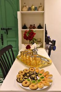 a table with a plate of donuts on a table at Riad Elijah and Spa Marrakech in Marrakech