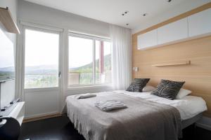 a bedroom with a large bed with a large window at Tott vacation homes in Åre