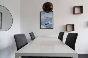 a white dining room with a white table and chairs at Tott vacation homes in Åre +71 photos