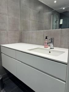 a bathroom with a white sink and a mirror at Tott vacation homes in Åre