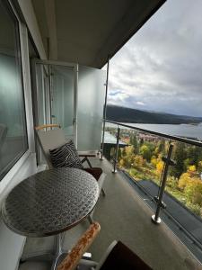 a table and chairs on a balcony with a view at Tott vacation homes in Åre