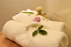 a couple of white towels with a flower on them at Riad Elijah and Spa Marrakech in Marrakech +10 photos
