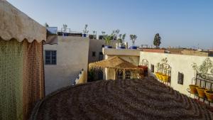 a view of a building with a straw roof at Riad ELJazouli in Marrakesh