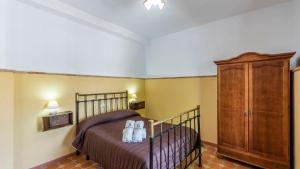a bedroom with a bed and a wooden cabinet at Cortijo El Llano Priego de Córdoba by Ruralidays in Priego de Córdoba +24 photos