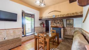 a living room with a couch and a table at Cortijo El Llano Priego de Córdoba by Ruralidays in Priego de Córdoba