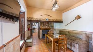 a living room with a couch and a table at Cortijo El Llano Priego de Córdoba by Ruralidays in Priego de Córdoba