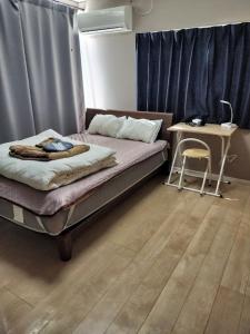 Postel nebo postele na pokoji v ubytování 個室101移住希望者激安マンスリー駅徒歩6分Atami Hakoneも近いゲストハウス真鶴