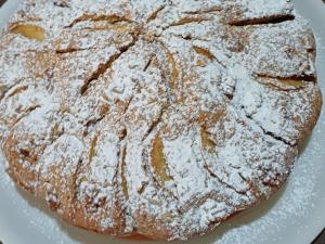 a pancake covered in powdered sugar on a plate at sa Domo Antiga in Pozzomaggiore