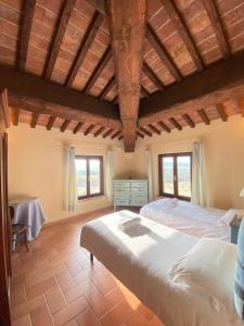 a large bedroom with two beds and a table at Tenuta La Casetta in Casciana Terme +46 photos