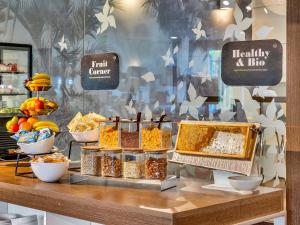 um balcão de padaria com diferentes tipos de alimentos em exposição em B&B HOTEL Milano Portello em Milão