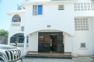 a jeep parked in front of a white building at Leah's Luxury Villa in Mombasa