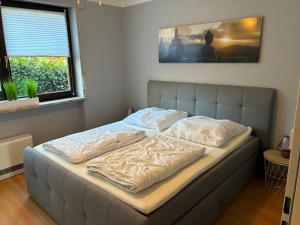 a bed in a bedroom with a bed frame at Wohnung HaHü in Dangast +11 photos