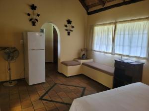 a room with a refrigerator and a window at Lush Horizons Game Lodge in Modimolle