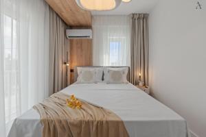 una camera da letto con un grande letto bianco con fiori sopra di DaVinci Smart Villa a Otopeni