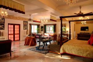 a bedroom with a bed and a living room at Ranbanka Palace in Jodhpur +49 photos