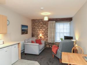 a living room with two chairs and a table at Beck View in Pickering