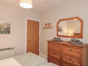 a bedroom with a dresser and a mirror at Beck View in Pickering