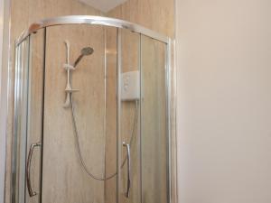 a shower with a shower head in a bathroom at Beck View in Pickering