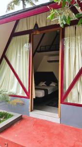 a small house with a bed inside of it at Pattaya Village in Kollam