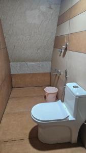 a bathroom with a toilet and a shower at Pattaya Village in Kollam
