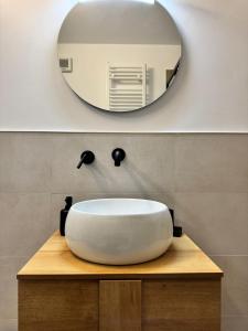 a bathroom with a white sink and a mirror at Tonale Sweet House in Passo del Tonale +23 photos