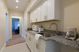 a kitchen with white cabinets and a sink at The Salem Inn in Salem