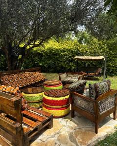 a group of chairs and ottomans sitting in a yard at Vota Ranch Luxury Stay & Nature Retreat in Machakos