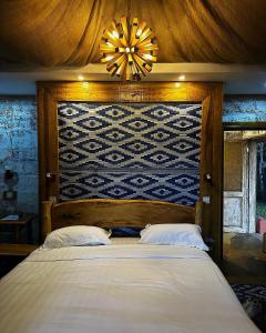 a bedroom with a large bed and a chandelier at Vota Ranch Luxury Stay & Nature Retreat in Machakos