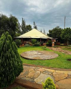 a large tent in a yard with a patio at Vota Ranch Luxury Stay & Nature Retreat in Machakos