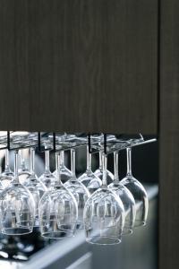 a row of wine glasses hanging from a rack at Mr,M都蘭 in Taitung City