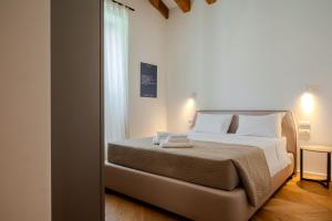 a bedroom with a bed with two towels on it at Palazzo Machiavelli Trieste in Trieste