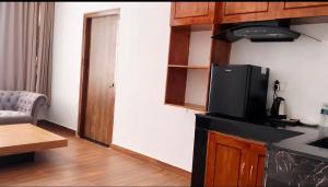 a living room with a kitchen with a tv on a counter at Hotel pema raga in Thimphu