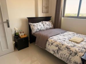 a small bedroom with a bed and a window at Flora Residence in Abu Dhabi +26 photos
