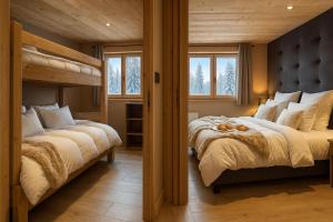 two beds in a room with two bunk beds at Résidence Bel Air, Univers Fantastique in Montriond
