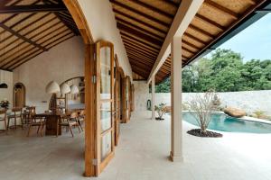 an external view of a house with a swimming pool at Uludream in Uluwatu