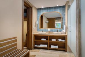 a bathroom with two sinks and a mirror at Zel Punta Cana - All Suites in Punta Cana