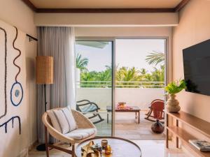 a living room with a view of the ocean at Zel Punta Cana - All Suites in Punta Cana