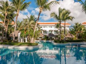 a resort with palm trees and a swimming pool at Zel Punta Cana - All Suites in Punta Cana +47 photos