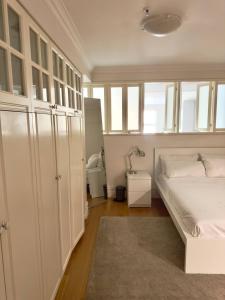 a bedroom with white cabinets and a bed with a rug at King Street Retreat in Perth