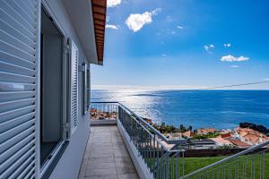 a balcony with a view of the ocean at Villa Infinityviews Madeira in Câmara de Lobos